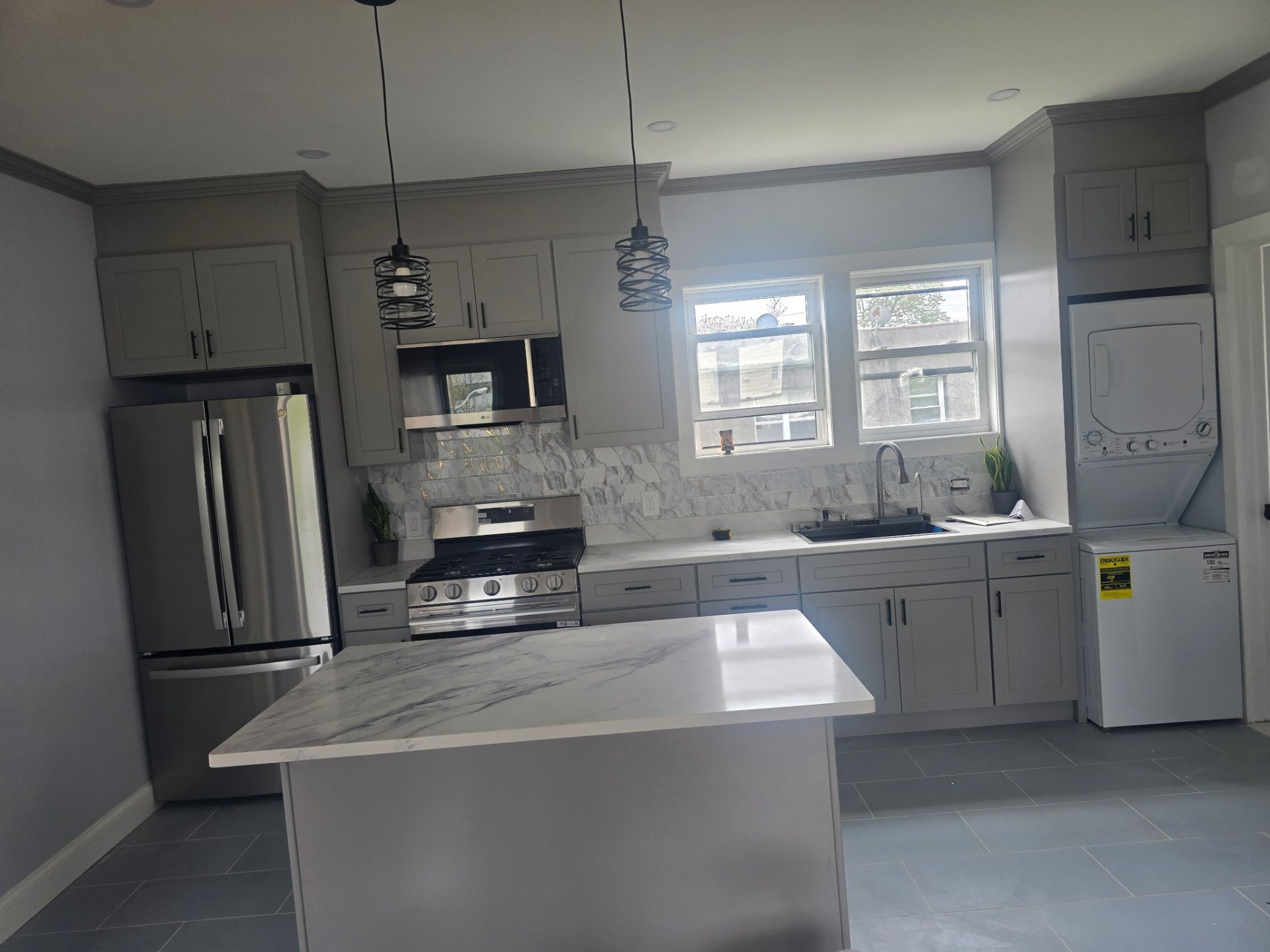 Gray shaker kitchen with marble waterfall island